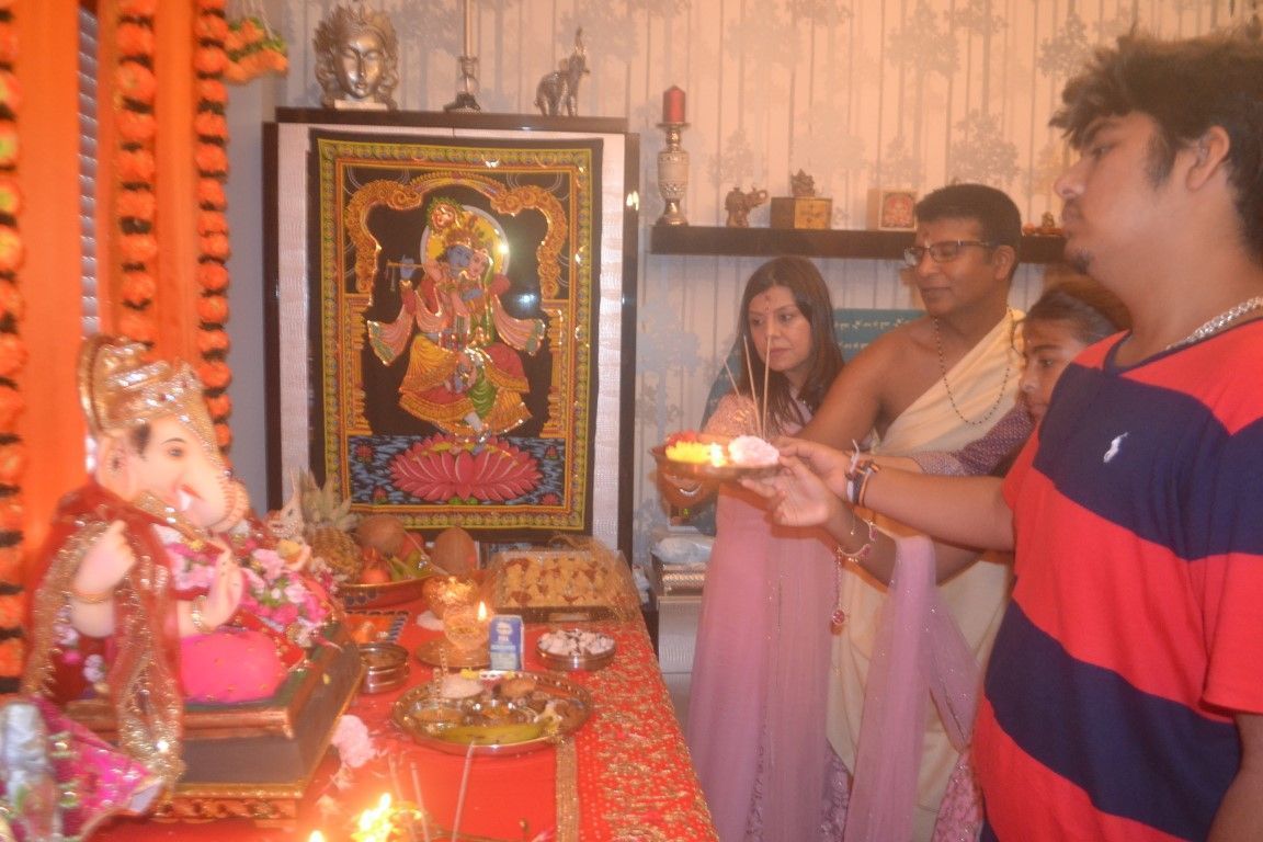 La familia de Vinod y Priya ofrecen árati.